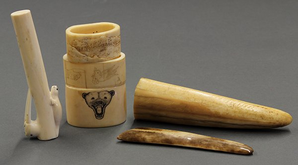 Eskimo artifact group: Eskimo carved artifact group, consisting of napkin rings, carved cane top, walrus tusk tip, and an early tool, possibly a scraper