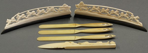 Eskimo carved impliments: (lot of 6) Eskimo carved impliments, consisting of three 19th century page turners with scrimshaw, together with two carved dogsled carvings rising on baleen bases, and a carved letter opener with hun