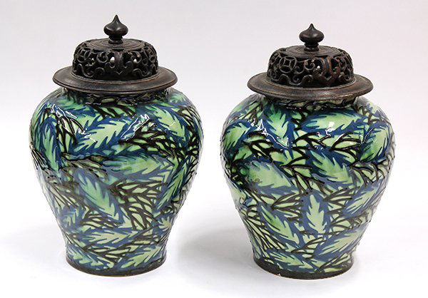Pair of Max Lauger ginger jars: Pair of Max Lauger covered jars, each having a pierce carved lid surmounting the shouldered slip decorated body with floral sprays continuing to the circular base, marked with cipher above Prof Lauger