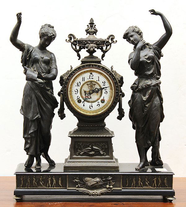 Ansonia Muses figural clock: Ansonia Muses figural clock, late 19th century. Executed in spelter and having double statues of musical muses centering a clock with 4.5" porcelain dial. The whole surmounting a black plinth with neo