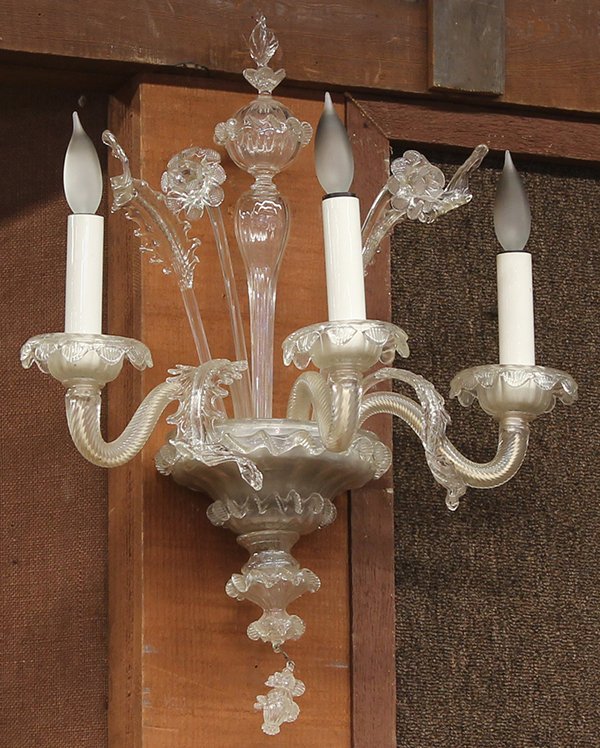 Venetian glass wall sconces: Venetian glass wall sconces, each three light fixture executed in clear glass with daffodil sprays fronting the blown finial capped accent suspended on an urn form support terminating with a drop fini