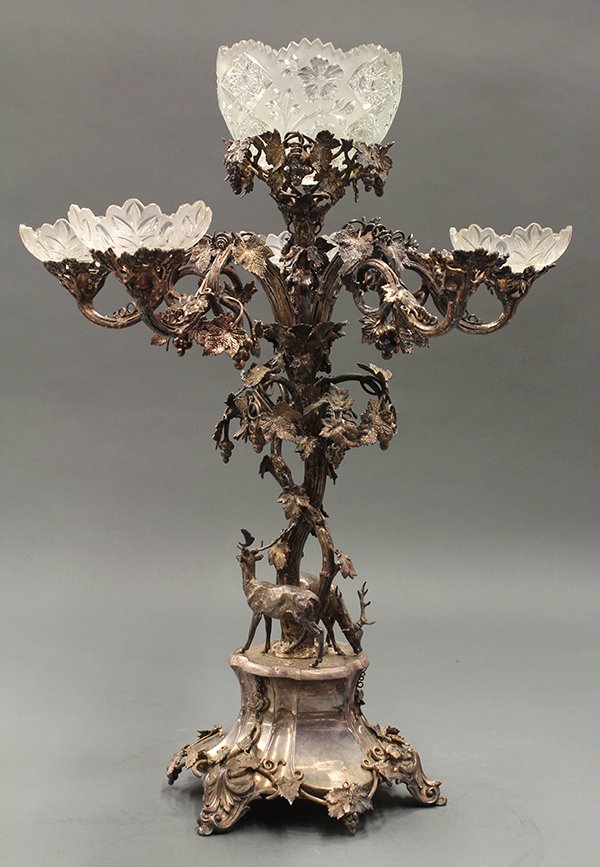 Renaissance Revival silverplate and glass epergne: Renaissance Revival silverplate and glass epergne, circa 1865, the glass bowls (one lacking) above a naturalistic grape leaf and vine standard supporting the five arms and terminating at the lower pli