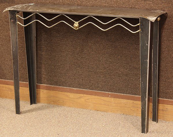 Modern metal console table: Moderne metal console table, 20th century. Executed in welded steel with gold accents. The rectalinear sheet steel top above a double zig zag apron centered with a gilt orb medallion and rising on tap