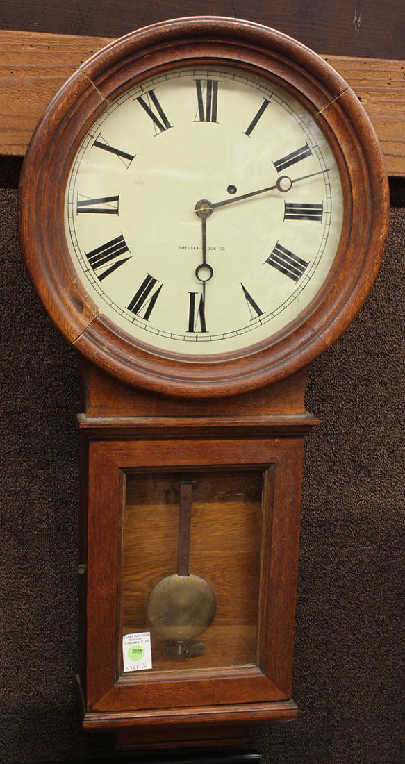 Chelsea Clock Co Wall Regulator clock, early 20th centu: Chelsea Clock Co. Wall Regulator clock, early 20th century. Chelsea Clock Company, Boston, Massachusetts. Oak case with lower glazed door, paper on zinc dial having Arabic numerals, black metal hands,