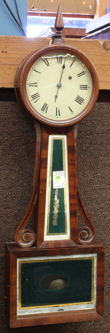 American mahogany banjo clock attributed to Horace Tift: American mahogany banjo clock attributed to Horace Tift, Attleboro MA circa 1850, the circular dial surmounting the eglomise decorated windows centered by the carved supports, 33"h x 10"w