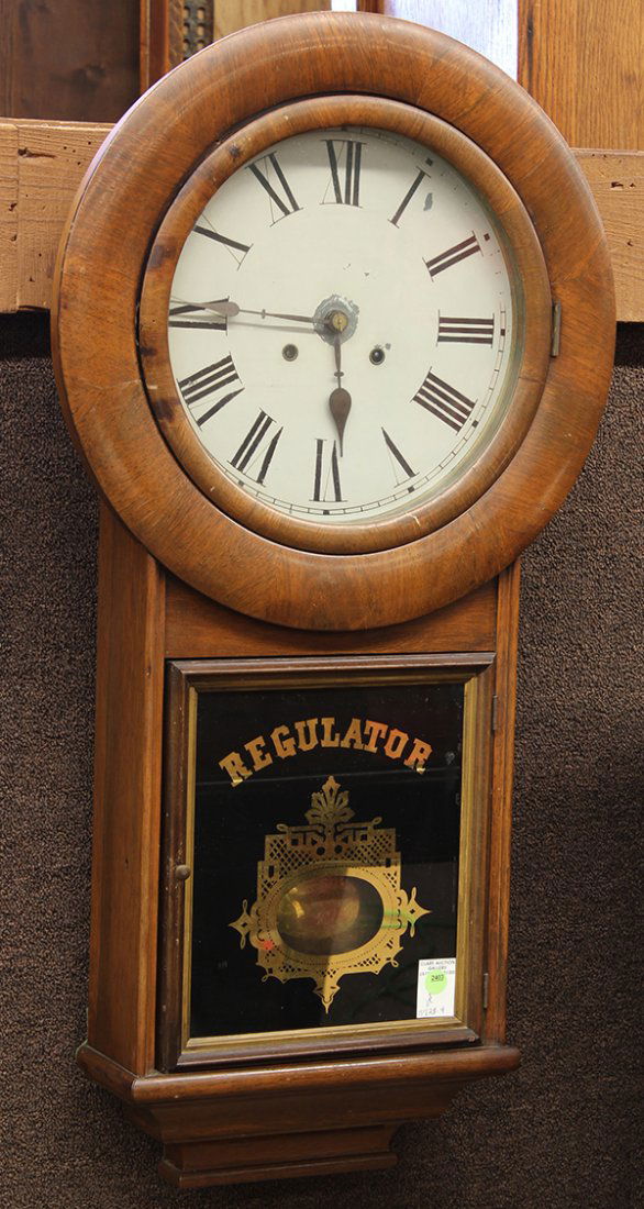 Gilbert regulator wall clock: Gilbert regulator wall clock, having a circular dial with Roman markers housed in a mahogany case with 2 weights, 36"h x 18"w