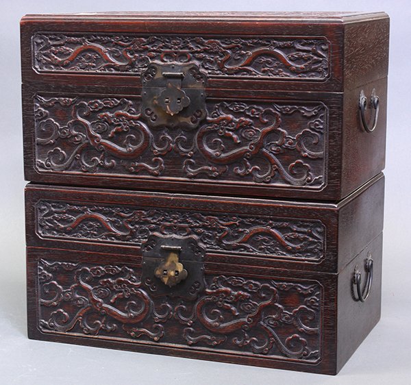 Chinese Small Wooden Trunks, Dragons: Pair of Chinese carved wooden chests, each with a hinged top lid, the front panel and lid carved with a pair of meandering dragons in pursuit of a flaming jewel, with metal fittings, 8"h x 15.75"w x 9