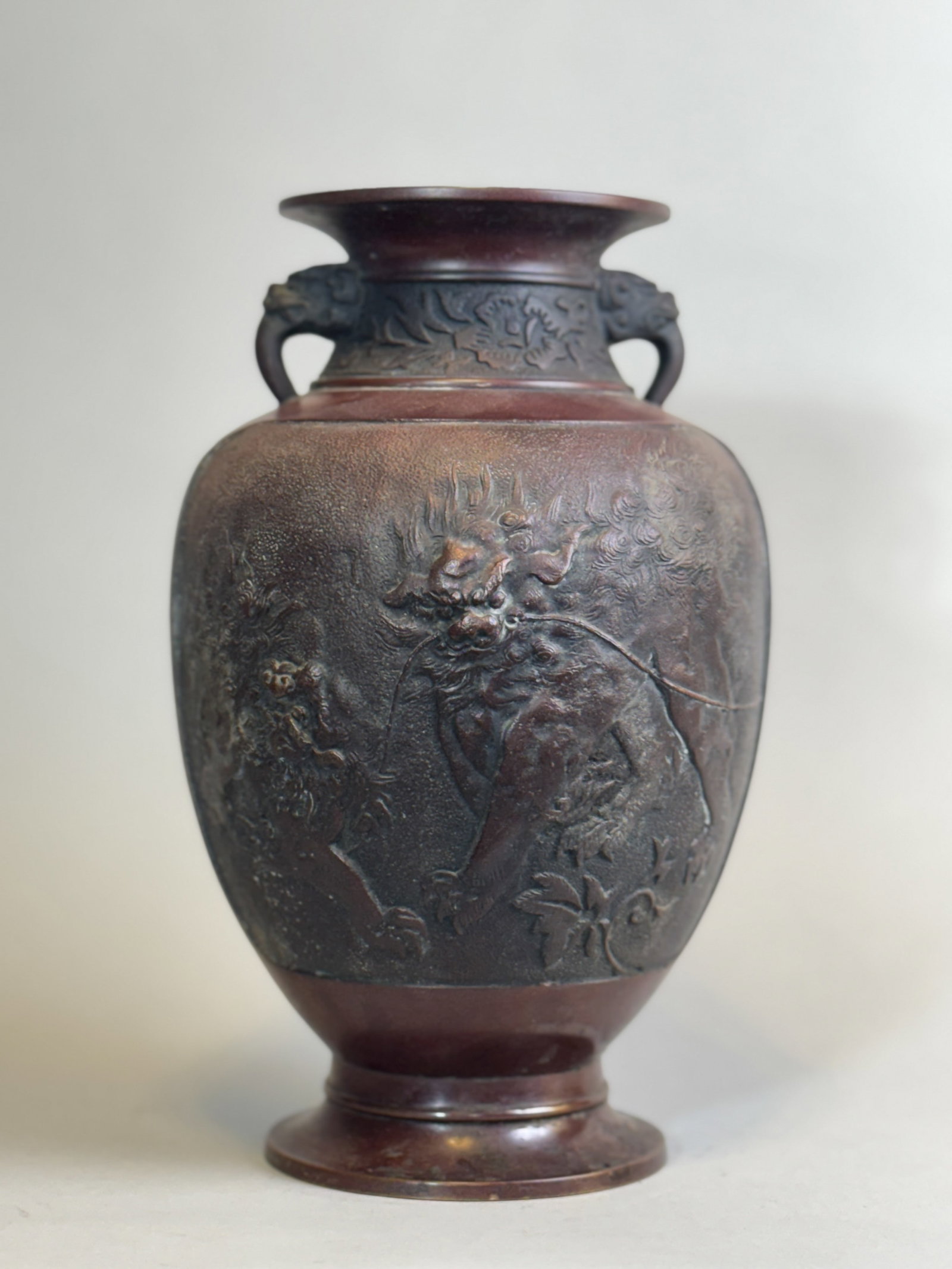Japanese Bronze Vase with Shishi, Meiji Period: Japanese Meiji period bronze vase with shishi, signed by the artist. 11.25"h (28.58 cm) NOTE: THIS ITEM IS IN OUR NEW YORK, WHERE IT CAN BE SHIPPED FROM.