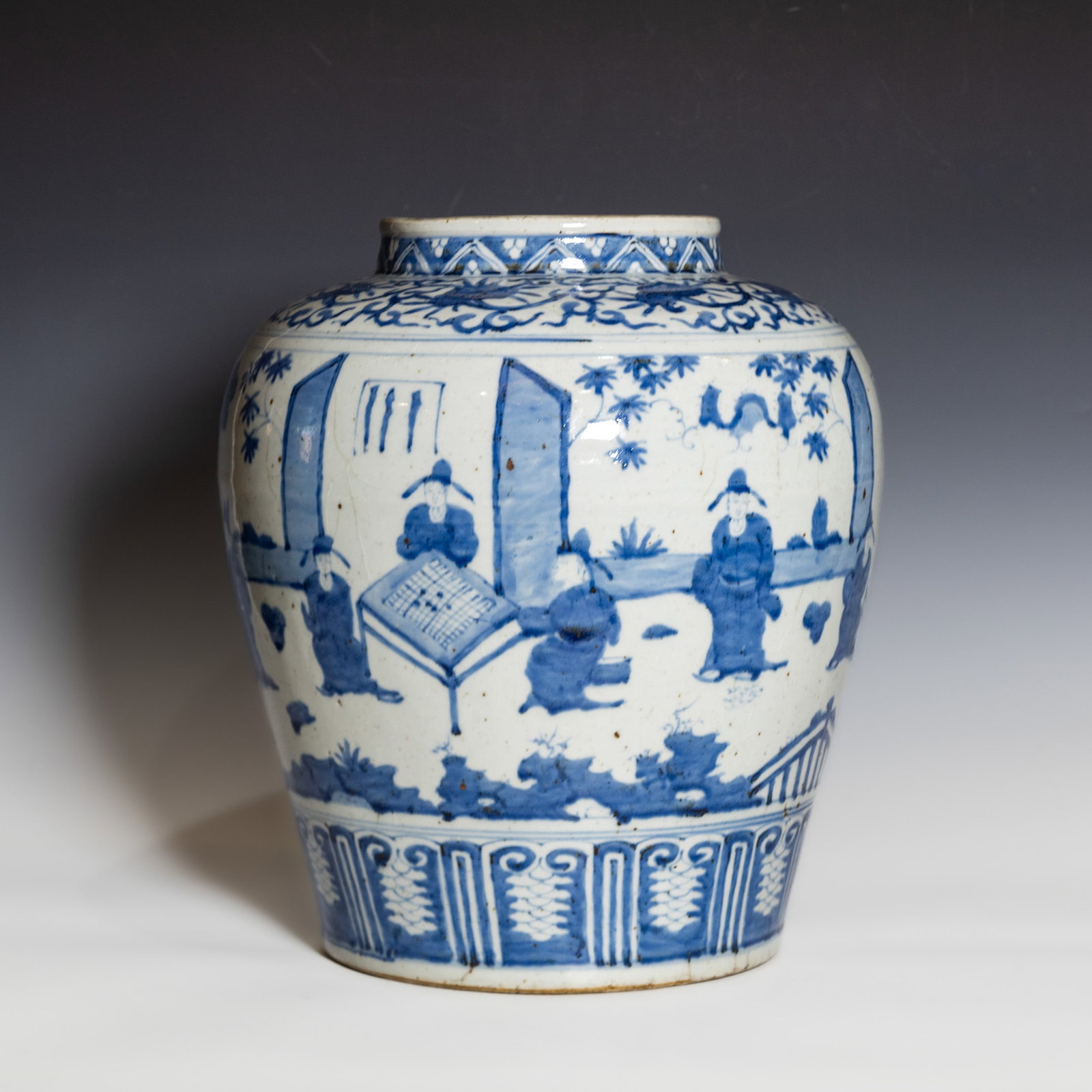 Chinese Blue and White Jar: Chinese blue and white jar of ovoid form, painted in underglaze blue with a continuous scene of scholars and attendants in a garden setting beneath a band of scrolling foliage and geometric patterns a