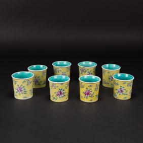 A Group of 8 Yellow Ground Famille Rose Cups
