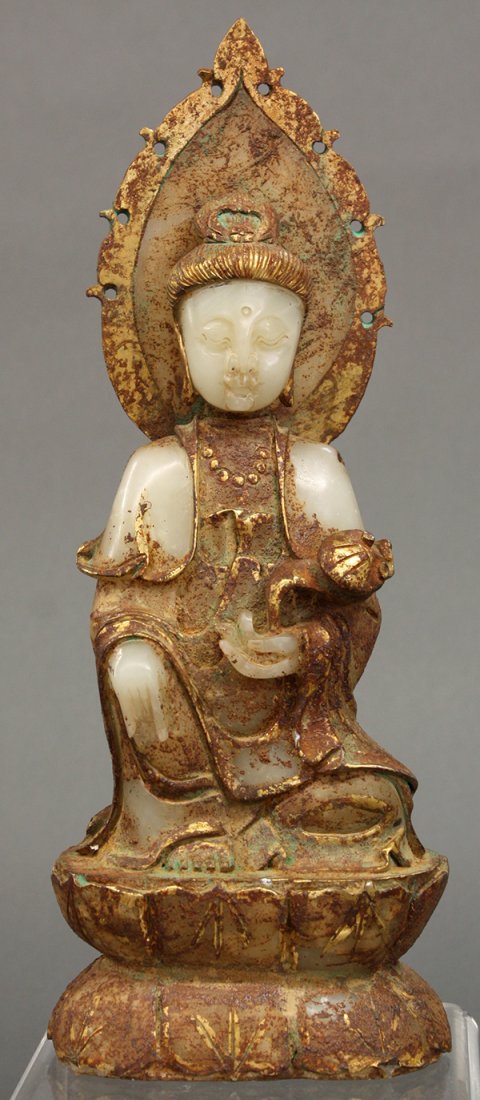 Chinese Gilt Stone Figure of Guanyin: Chinese gilt stone carving of Guanyin, seated in laliasana and holding a ruyi scepter, backed by a mandorla and above a lotus pedestal, the white stone with areas heightened in gilt pigment, 13.5"h
