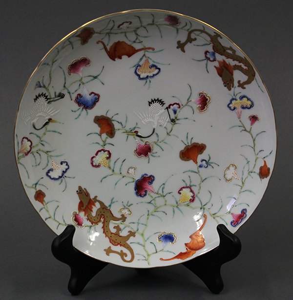 Chinese Porcelain Plate, Dragons and Cranes: Chinese polychrome enameled porcelain plate, the interior brightly decorated with a pair of dragons, bats and cranes amid stylized lingzhi, the base with an apocryphal Jiaqing mark, 9.75"w