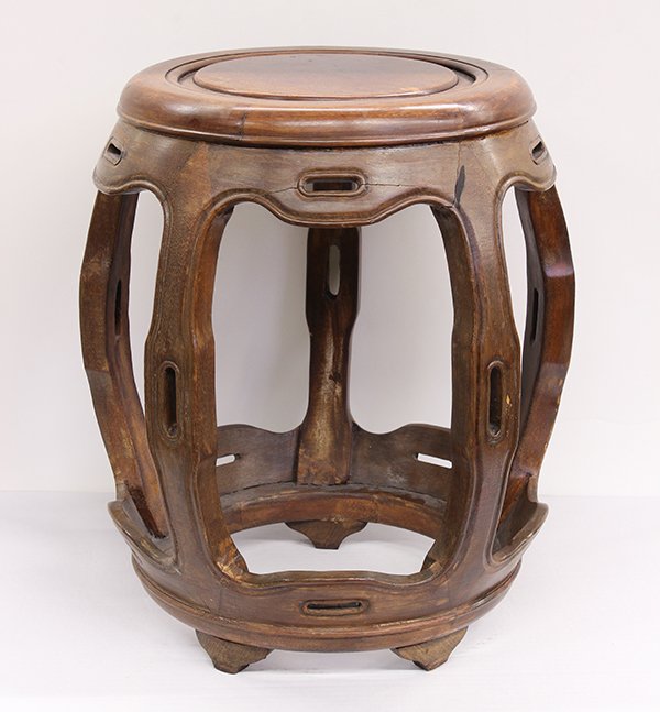 Chinese Wooden Barrel Stool: Chinese hardwood barrel stool, with apertures to the shaped apron, slotted supports and a circular base, 18.25"h