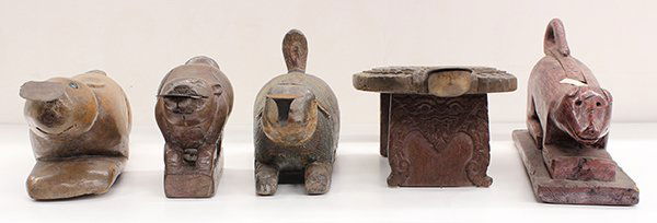 Five Thai Wood Coconut Graters: (lot of 5) Group of Thai coconut graters, one in the shape of a turtle, three rabbits and a carving of a zoomorph with a long tail, largest rabbit: 21.5"l