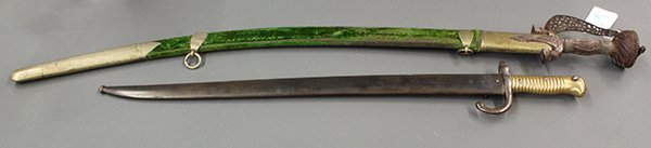 Scimitar and sabre: Two vintage swords including a scimitar mounted with a pieced knuckle bow, and resting in a green velvet scabbard with brass fittings, 38"l; together with a sabre mounted with a brass grip, and restin