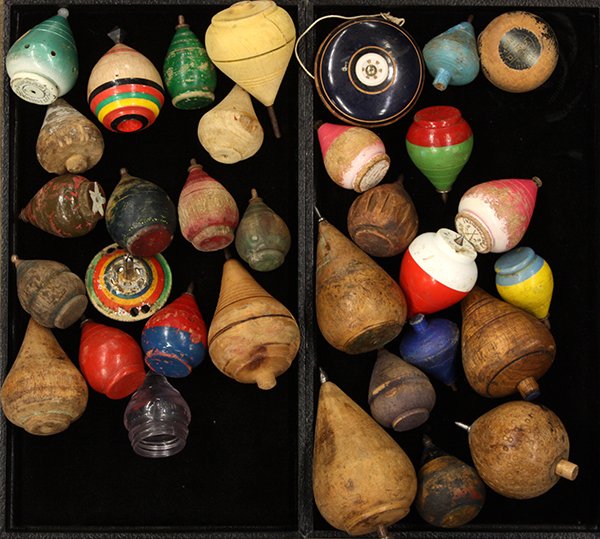 Collection of early tops and yo-yos: (lot of 32) Collection of early tops and yo-yos, executed mostly in turned wood with one glass and one tin top, including a Duncan tournament top and a Duncan Whistler