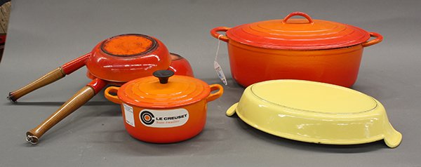 Le Creuset enameled cookware, 1970-2000: (lot of 5) Collection of Le Creuset cookware, 1970-2000, executed in enameled orange and yellow cast iron consisting of a large oval dutch oven with lid, oval gratin pan, covered tureen, and two saute