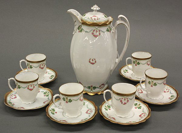 M. Z. Austria (Moritz Zdekauer) chocolate service, circ: (lot of 13) M. Z. Austria (Moritz Zdekauer) porcelain hot chocolate service, circa 1900, consisting of a chocolate pot and six demitasse cups and saucers, the service decorated with swags and pink flo
