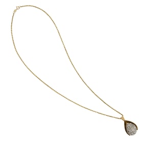 A diamond and 14k gold pendant necklace