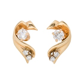 A pair of diamond and 14k gold studs with jackets