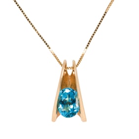 A topaz and 14k gold pendant necklace