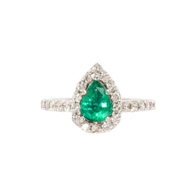 An emerald, diamond, and 14k white gold ring