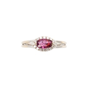 A pink sapphire, diamond, and 18k white gold ring