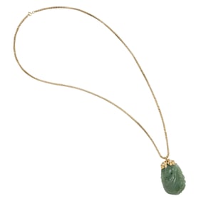 A jade and 14k gold pendant necklace