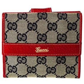 A vintage Gucci blue monogram canvas wallet with red leather trim
