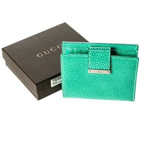 A Gucci turquoise leather bifold wallet with silver tone hardware includes factory box