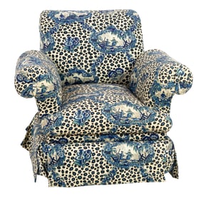 A swivel rocking lounge chair upholstered in Brunschwig & Fils 'Chinese Leopard' pattern fabric