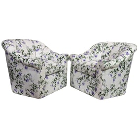 A pair of swivel lounge chairs