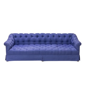 A large Chesterfield style sofa with ottoman in periwinkle
