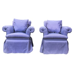 A pair of light purple swivel lounge chairs
