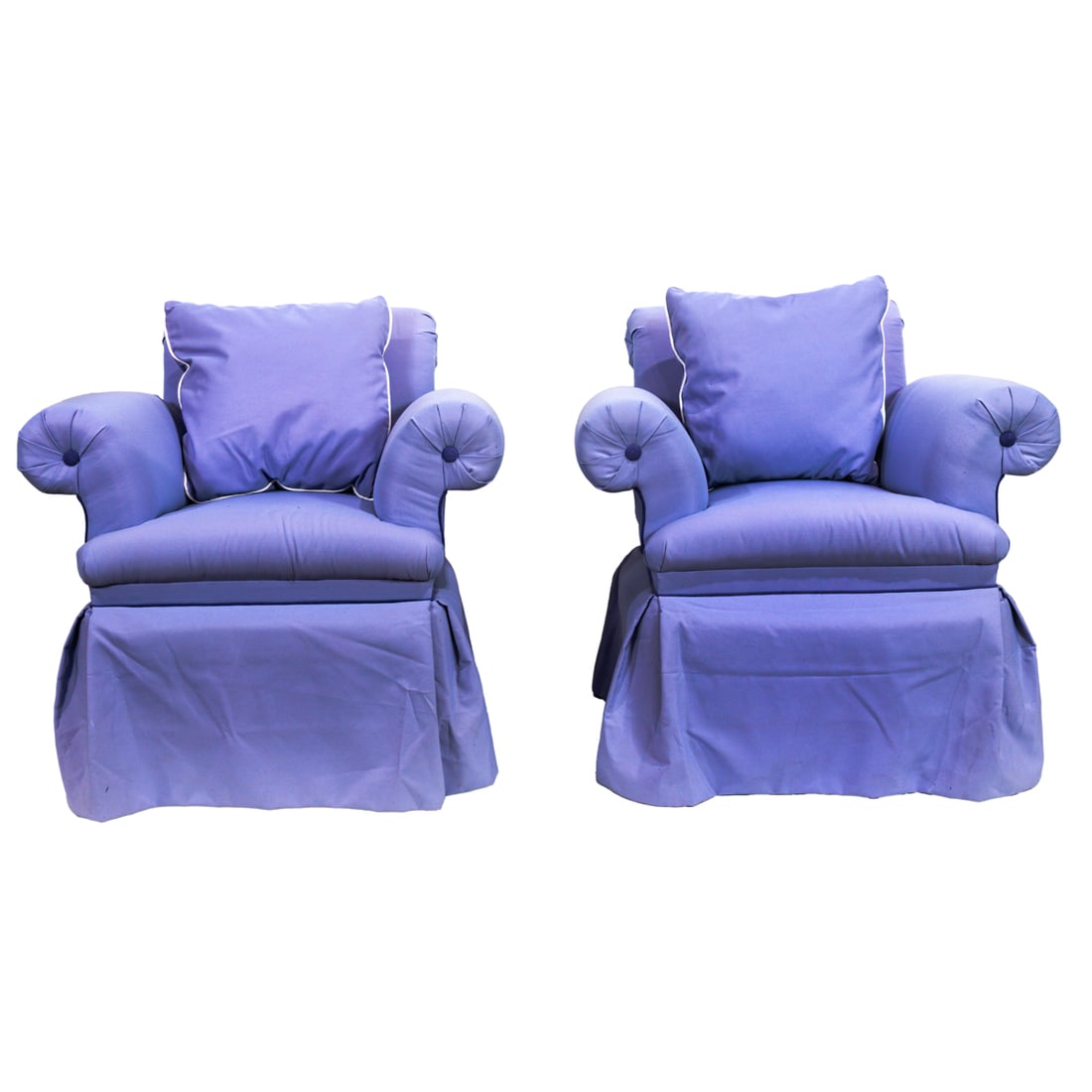 A pair of light purple swivel lounge chairs: A pair of light purple swivel lounge chairs, each with sway back and rolled arms, purple buttons and piping, with a skirted base, 32.5"h x 33"w x 33"d, seat 18"h. Provenance: The Carole Harris Collect