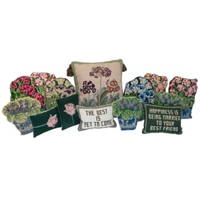 Fourteen needlepoint throw pillows