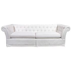 A Chesterfield style sofa in white with skirted base