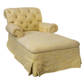 A tufted chaise lounge in muted yellow jacquard upholstery