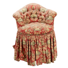 An upholstered and skirted vanity table chair with revolving seat