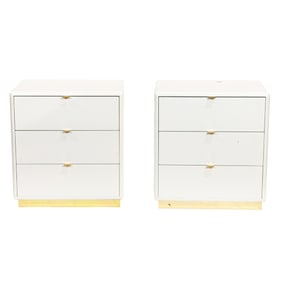 A pair of contemporary white three-drawer nightstands