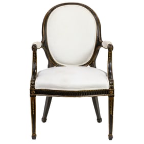 A Louis XVI style ebonized and parcel gilt armchair