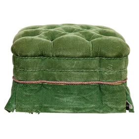 A muted green square tufted ottoman