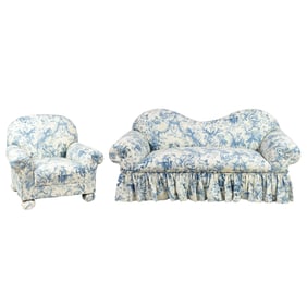 A sofa and lounge chair upholstered in Chinoiserie toile fabric