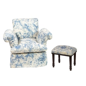 A lounge chair and stool upholstered in Chinoiserie blue toile fabric