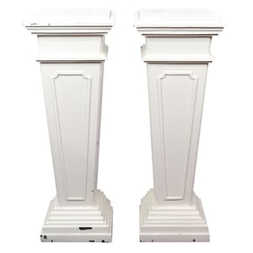A pair of Classical style white painted pedestals