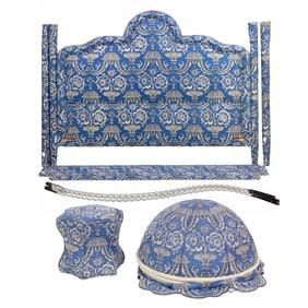 A blue and white upholstered bed