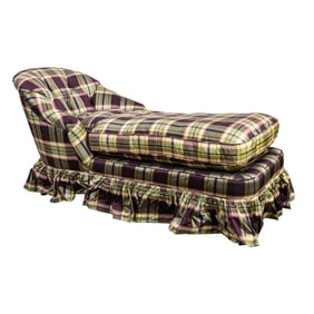 A tufted chaise upholstered in auberge and green plaid taffeta