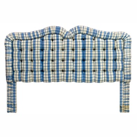 A blue and ivory taffeta upholstered headboard with giltwood wreath and matching fabric panel