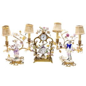 A Continental floral encrusted gilt metal and porcelain figural assembled clock garniture