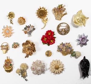 Twenty-one costume jewelry brooches of various flowers